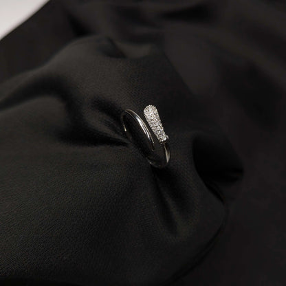 Silver ring with gemstones on a black fabric background